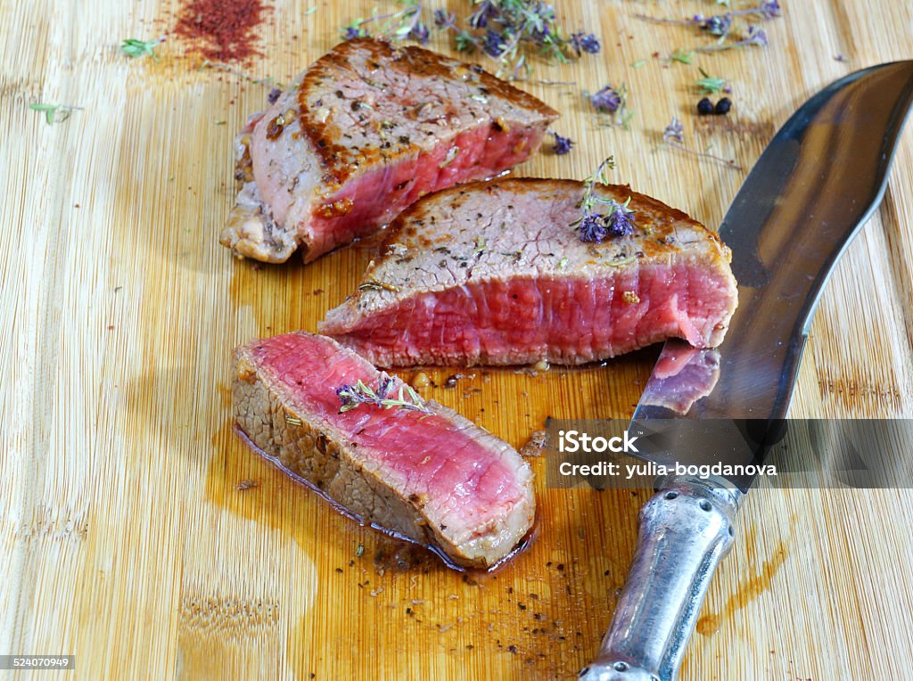beef steak rare on the wooden cutting board beef steak rare Barbecue - Meal Stock Photo