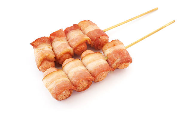 istock fried sausage rolled with bacon and spicy sauce 524071125