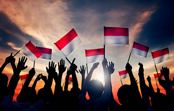 Group of People Waving the Flag of Indonesia stock photo