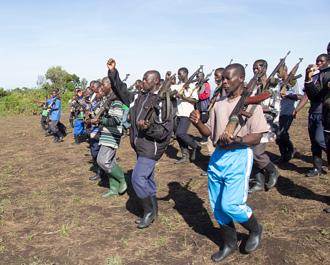 Chai, North Kivu, DRC - March 29, 2014: FDLR soldiers marching and training on an abandon football field before patrols.