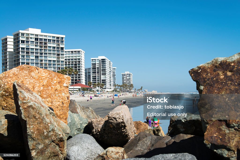 Coronado Beach San Diego Coronado, USA - June 1, 2014: People sunbathing, walking and swimming at the beach on the Coronado Island near San Diego in California, USA. Beach Stock Photo