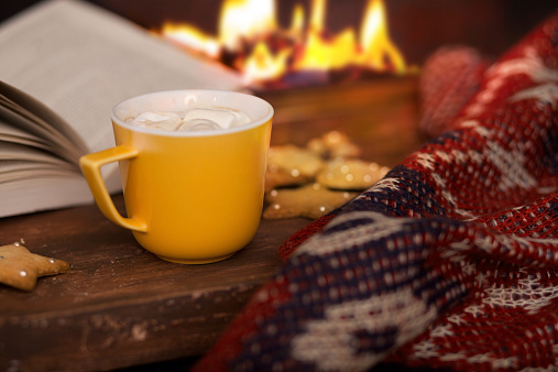 cup of hot cocoa on a background of fire