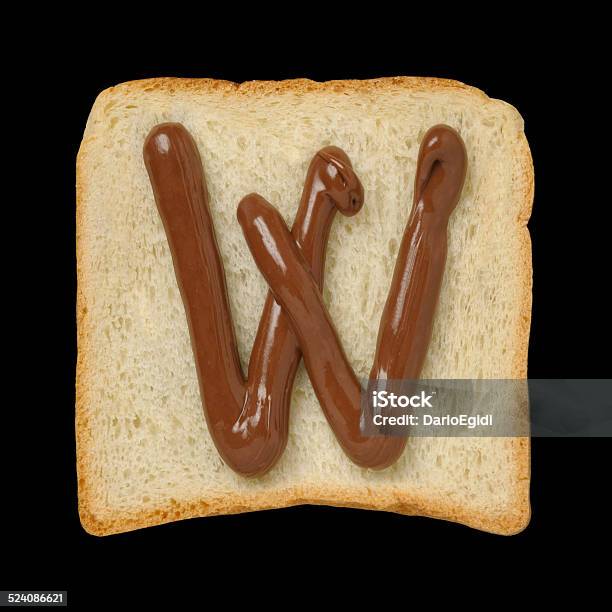 Chocolate Letter W On A Tinloaf Slice Black Background Stock Photo - Download Image Now