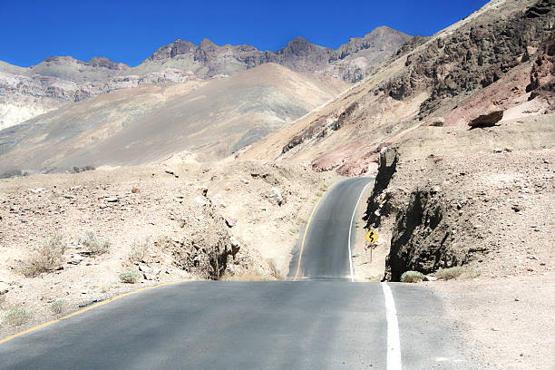 Yellow Road sign - USA desert road - Bright light stock photo