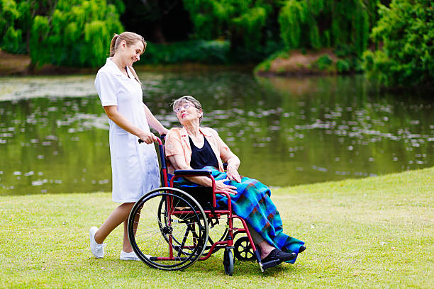 istock Affectionate moment between nurse and her elderly wheelchair-bound patient 524088473