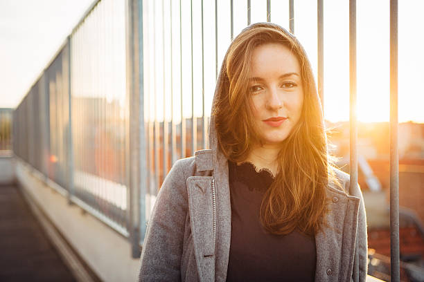 istock modern young woman portrait in urban scene with back lit 524088805