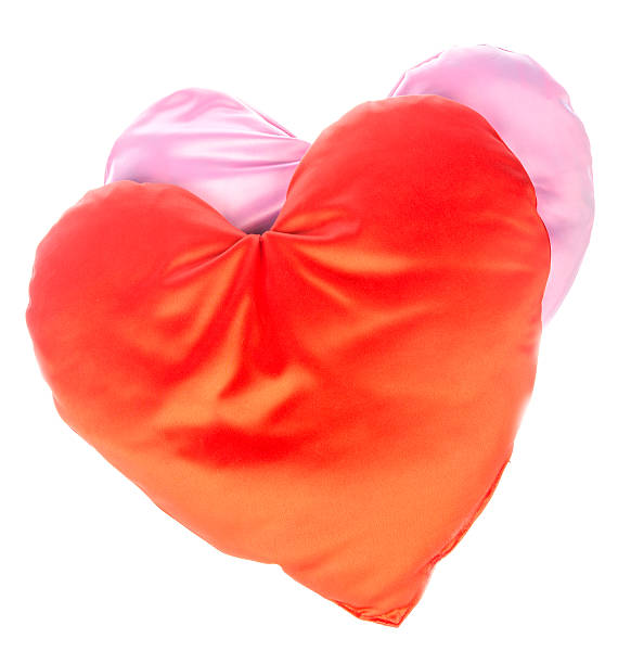 Heart-shaped pillows Two red and pink heart-shaped pillows. Isolated on white red cushion covers stock pictures, royalty-free photos & images