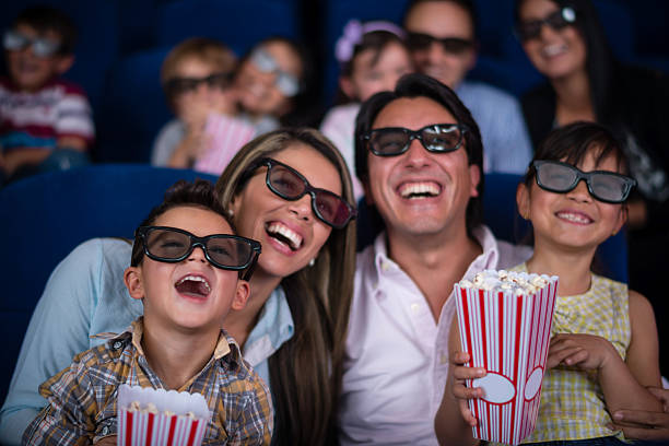 Girl watching movies at the cinema with her grandmother and grandfather.