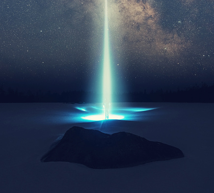 A person is beamed off the surface of a frozen lake into the stars. Composite image.