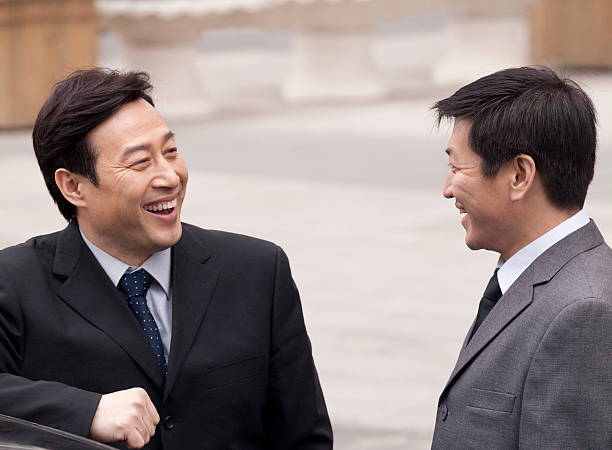 businessmen smiling to eachother