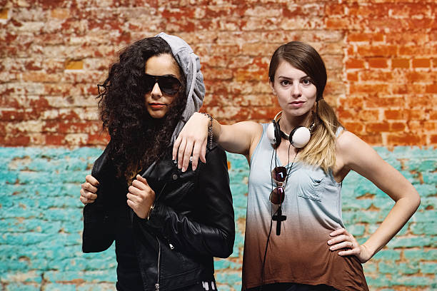 istock Two women standing in front of brick wall 524090973