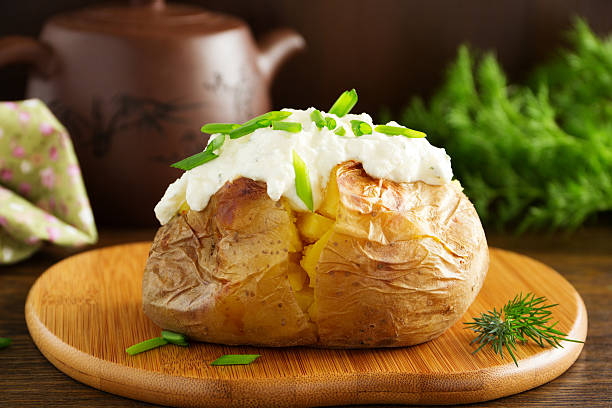 Baked potato with cream of the cream cheese closeup. Baked potato with cream of the cream cheese closeup. baked potato stock pictures, royalty-free photos & images