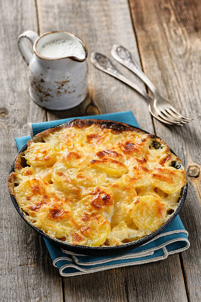 Potato gratin in casserole with cream and cheese stock photo