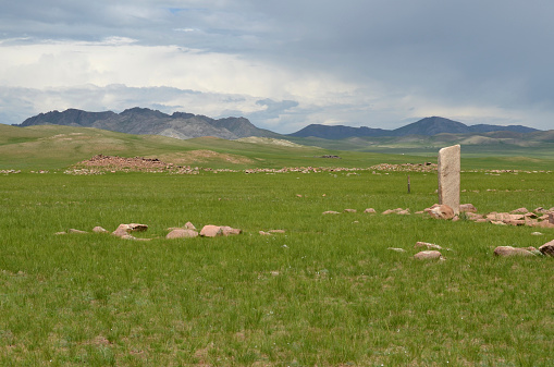 Deer stone in the foreground and funeral mound in the background, near the town of Moron, Hovsgol province.