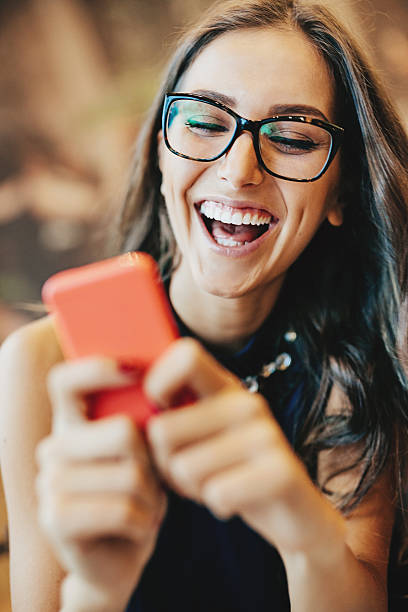istock Young woman texting on smart phone 524129315
