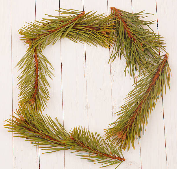 istock Frame from the pine branches on a white wooden background 524129839