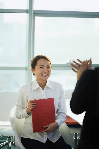 istock Businesswoman holding file and smiling 524129863