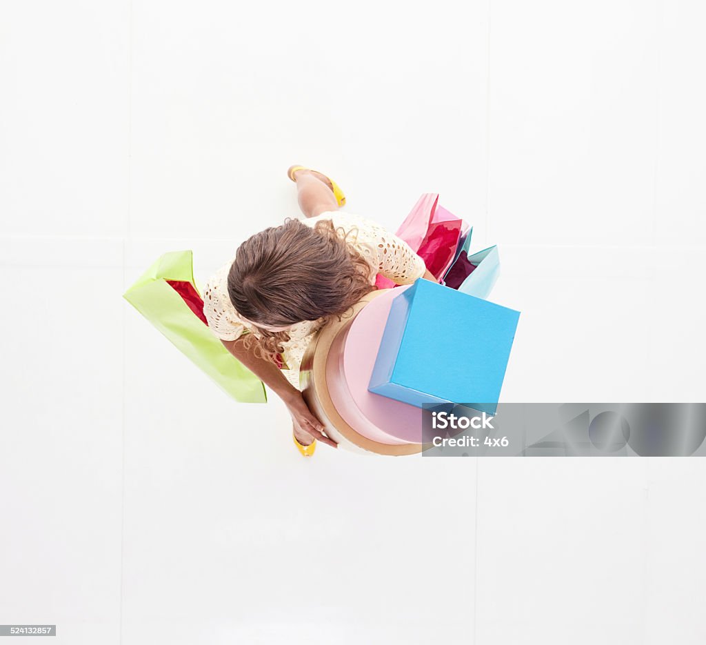 Above view of woman holding gift box & bag Above view of woman holding gift box & baghttp://www.twodozendesign.info/i/1.png 30-34 Years Stock Photo
