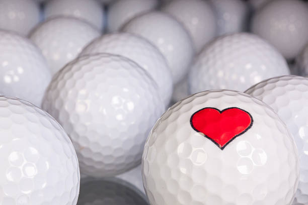 istock Golf balls with love symbol on the black glass table 524133809