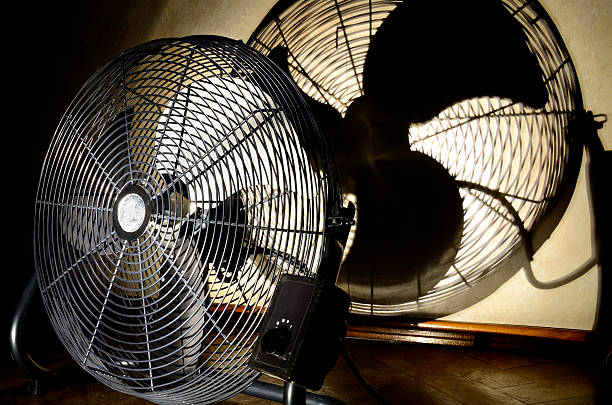 istock Electric fan and silhouette on wall 524134715