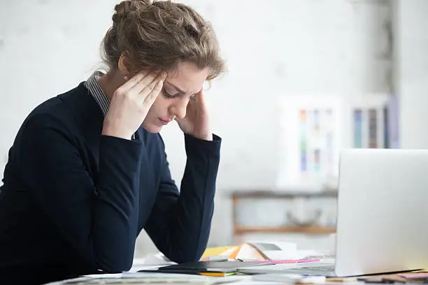 Photo of Young worried businesswoman