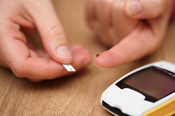 closeup of female finger with blood0 drop and test stripe closeup of female finger with blood drop and test stripe, concept of illness, diabetes, high glycemic level in blood hyperglycemia stock pictures, royalty-free photos & images