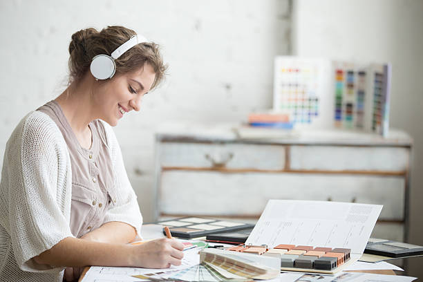 Cheerful young woman listening music at work