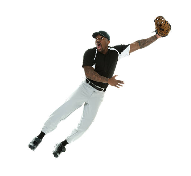 Shocked baseball player jumping & catching the ball