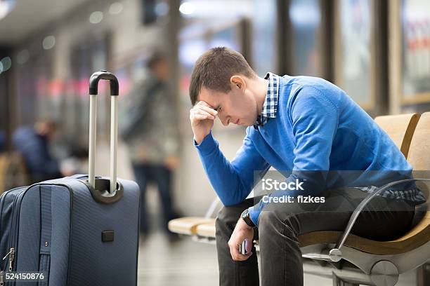 Young Frustrated Man At Airport Stock Photo - Download Image Now - Airport, Waiting, Displeased