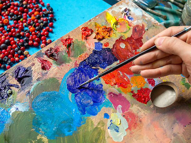 istock Female hands, paint brushes, oil paints and palette 524150970