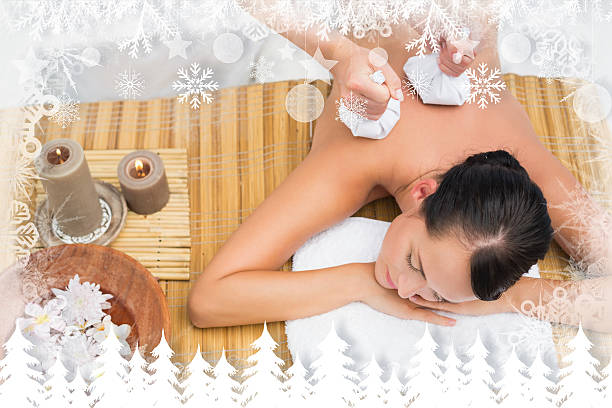 istock Peaceful brunette enjoying a herbal compress massage 524151147