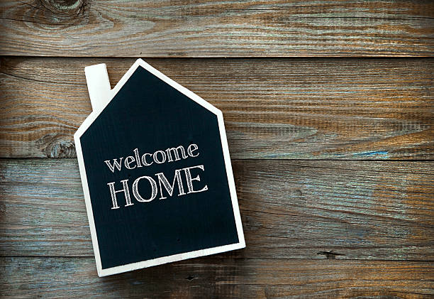 istock House Shaped Chalkboard sign on rustic wood WELCOME HOME 524151953