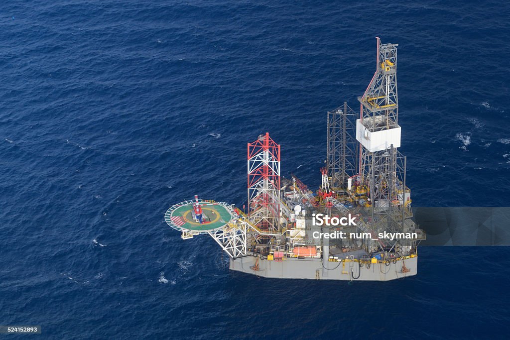 helicopter pick up passenger on the offshore oil rig. Top view of helicopter pick up passenger on the offshore oil rig. Natural Gas Field Stock Photo