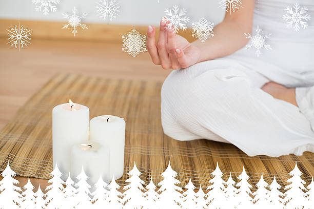 istock Woman sitting in lotus pose beside white candles 524152939