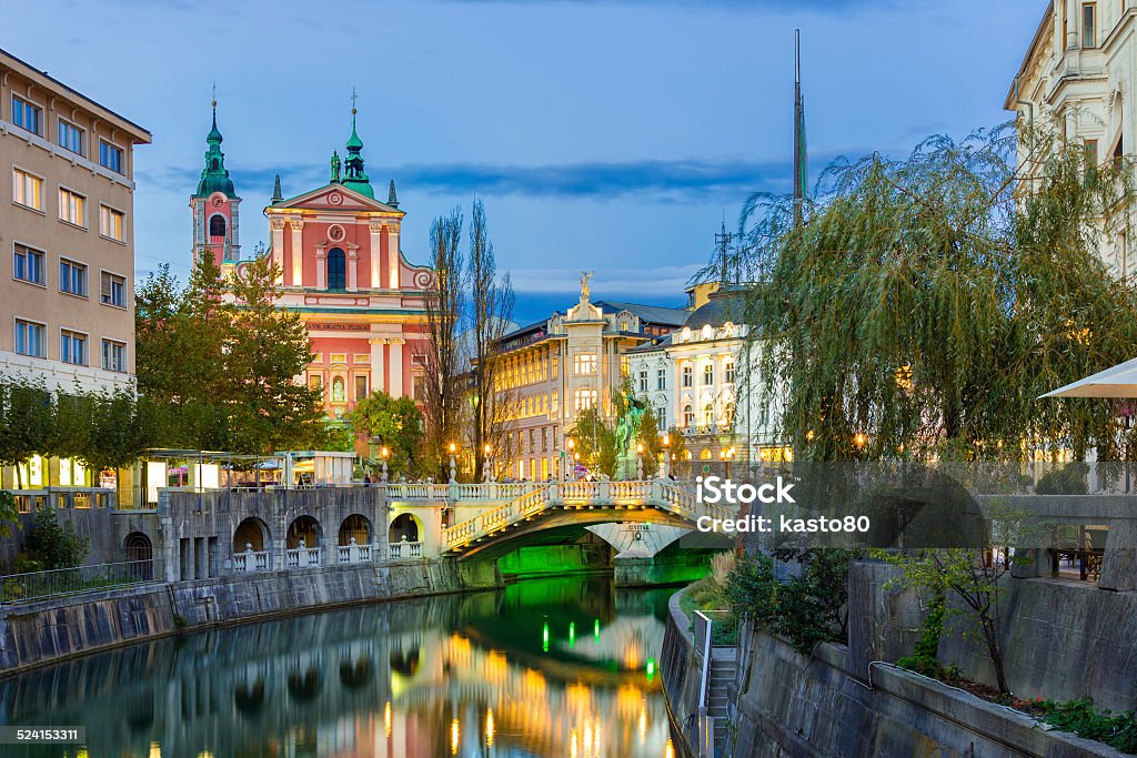 Romantic medieval Ljubljana, Slovenia, Europe. Romantic medieval Ljubljana's city center, capital of Slovenia, Europe. Night life on the banks of river Ljubljanica where many bars and restaurants take place. Franciscan Church in background Ljubljana Stock Photo