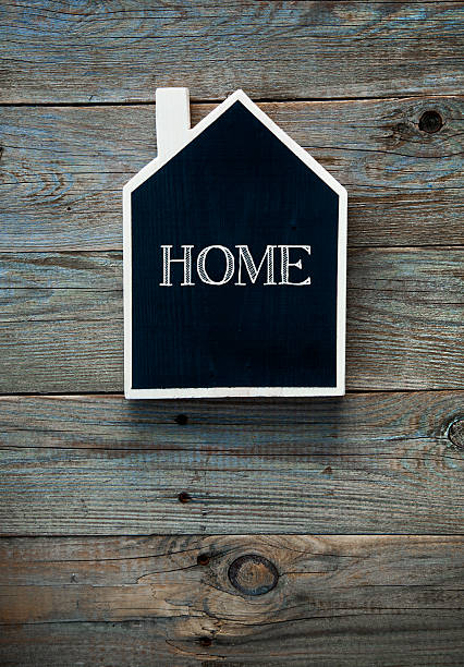 istock House Shaped Chalkboard sign on rustic wood  HOME 524153773