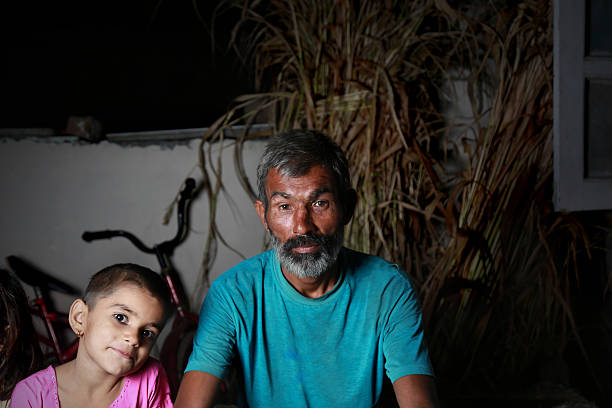 Father and daughter sitting Together in the Night portrait taken using Studio Lights.