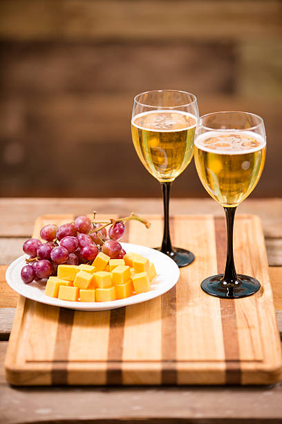 istock White wine tasting event. Cheese and red grapes. Wooden table. 524155501