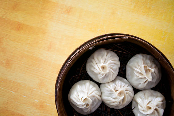chinese steamed dumplings in bamboo steamer