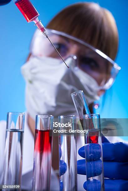 Laboratory Woman In The Lab Experimenting Stock Photo - Download Image Now - Adult, Adults Only, Analyzing