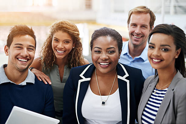 Together, success is a given Portrait of a group of smiling coworkers standing in an office multi ethnic group group of people people smiling stock pictures, royalty-free photos & images