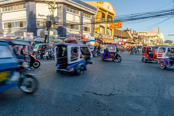 Motorized tricycle traffic. Iloilo, Philippines - February 13, 2016. Motorized tricycle Traffic in Iloilo Philippines philippines tricycle stock pictures, royalty-free photos & images