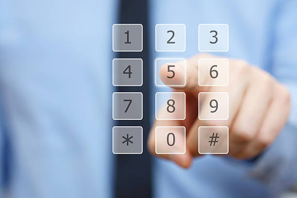 istock closeup of businessman's hand dial a number on virtual keypad 524158438