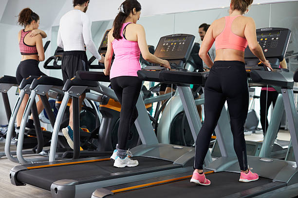istock People Using Equipment In Busy Gym 524158728