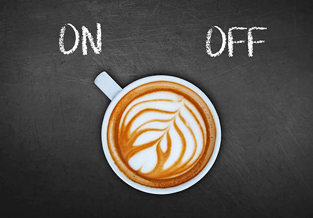 istock Cup of coffee on black board switching on 524158834
