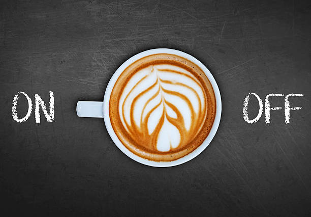 istock Cup of coffee on black board switching on 524158912