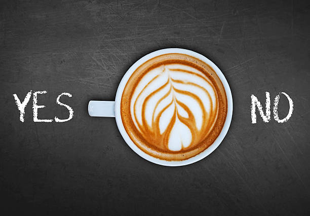 istock Cup of coffee on black board switching yes 524159108