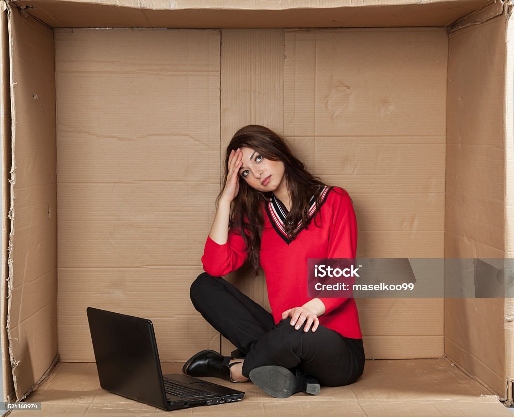 depressed business woman sitting in the office Box - Container Stock Photo