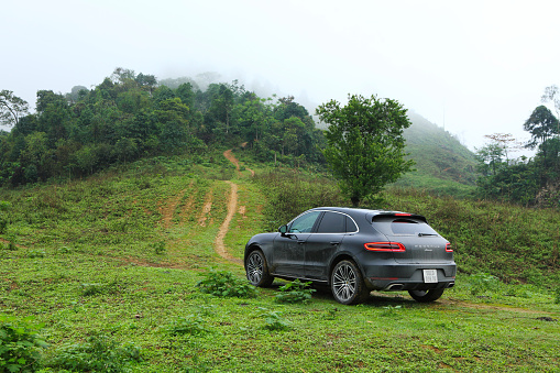 Hoa Binh, Viet Nam - March 27, 2015: Porsche Macan 2015 car running on the mountain road in Vietnam