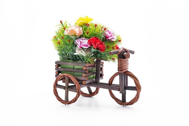 istock Wooden tricycle toy with carnation on white background. 524161606